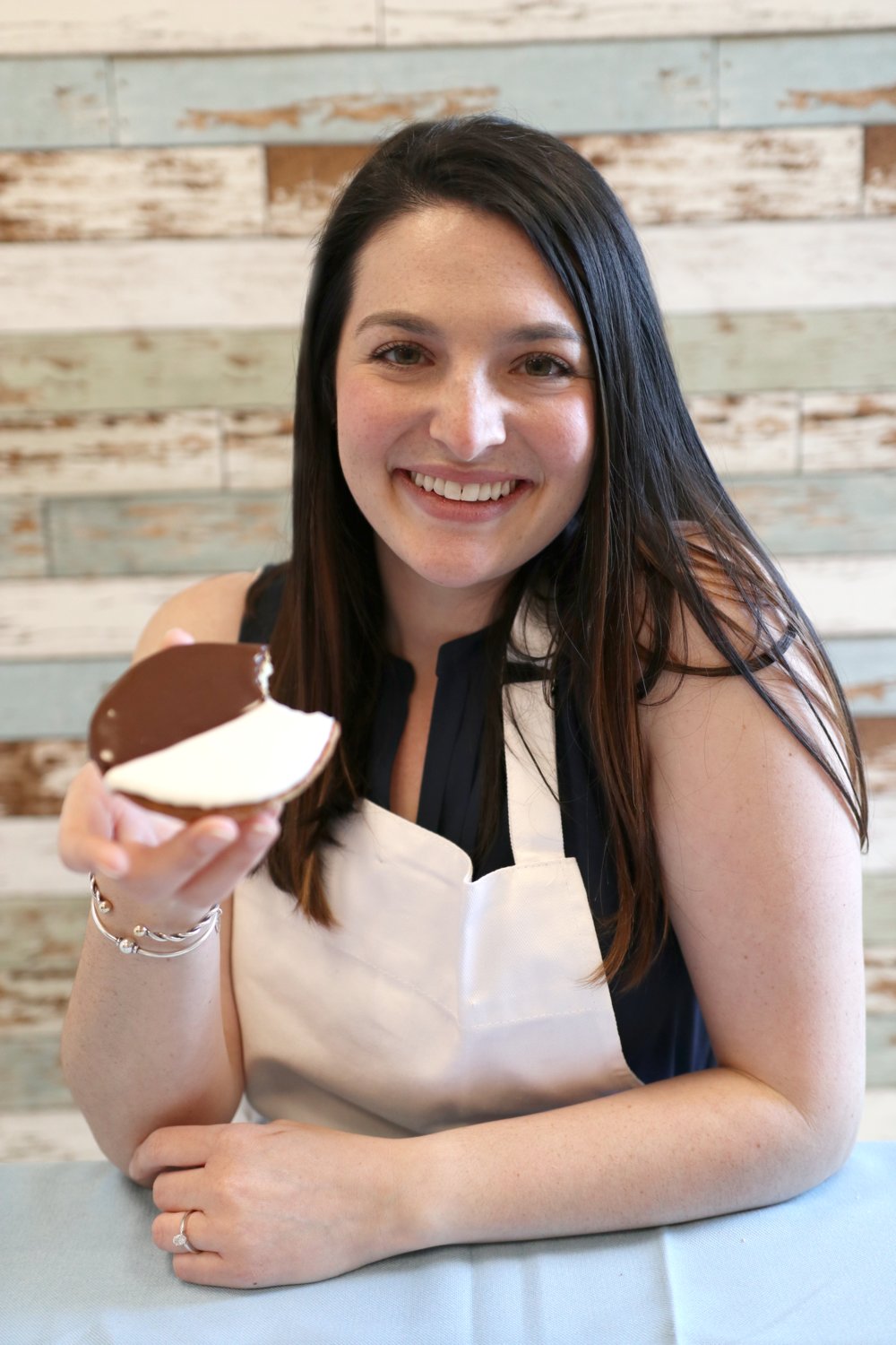 Lisa Maybruch samples a freshly baked black and white cookie.